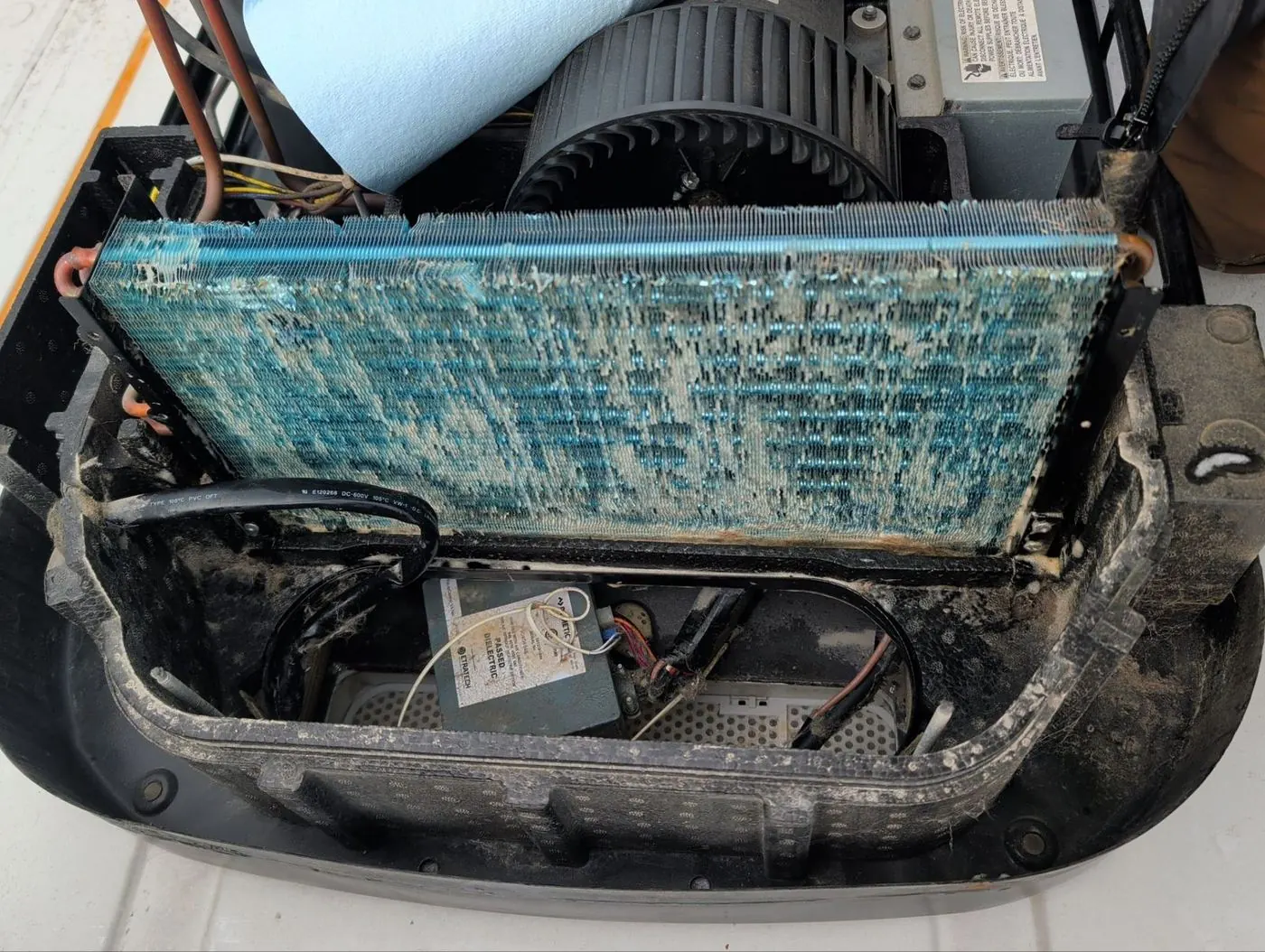 Heavily fouled RV air conditioner coil and blower before cleaning
