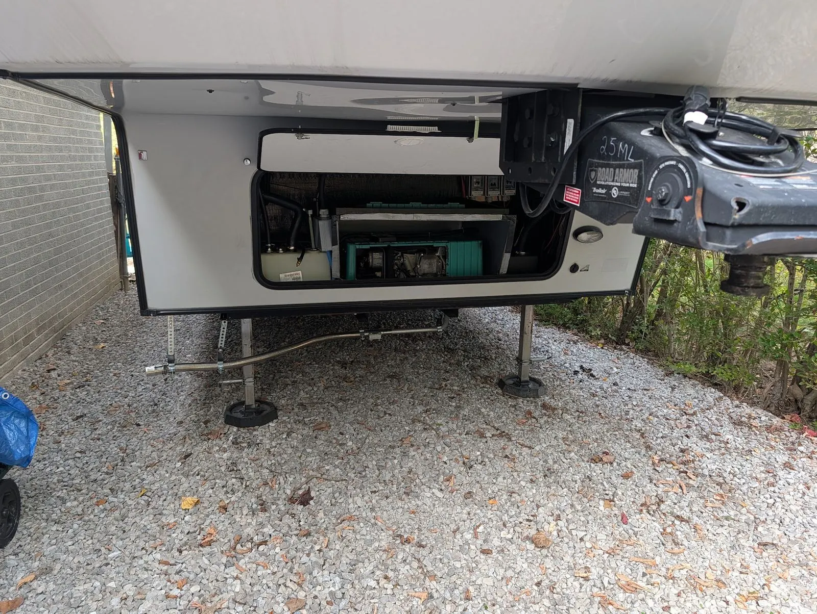 Open generator bay on a fifth wheel with the onboard generator visible