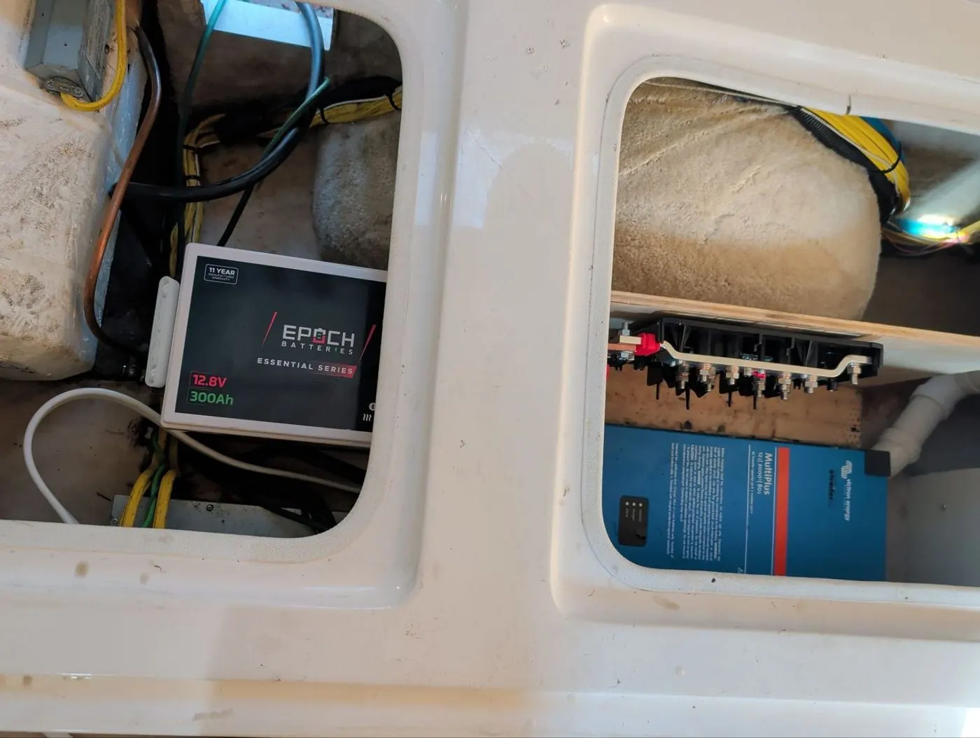 Epoch 300Ah lithium battery in an exterior compartment beside a Victron MultiPlus and fused busbar