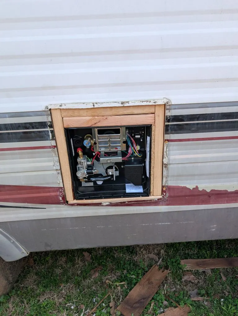 New RV water heater installed in a rebuilt exterior access opening