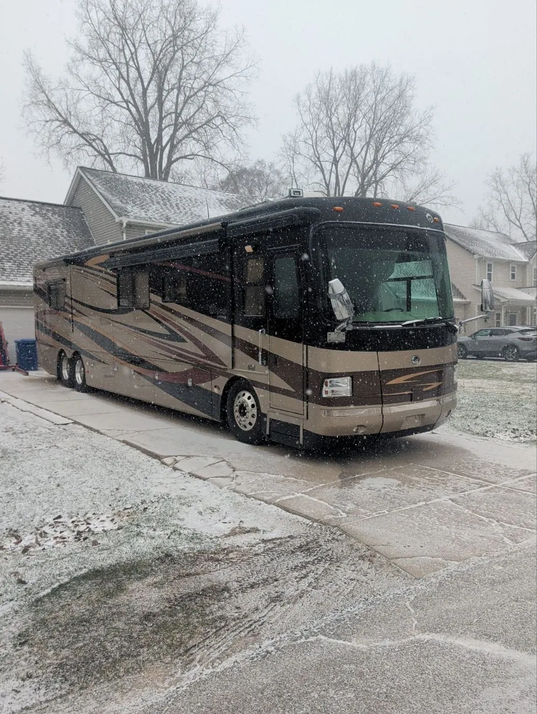 Class A diesel pusher motorhome parked in a driveway during a winter service call