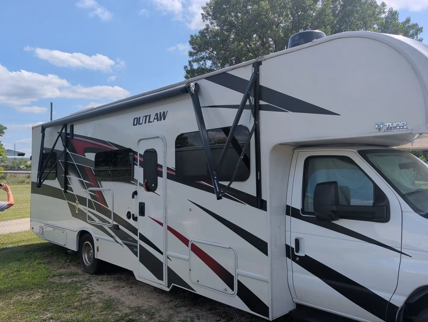 Class C toy hauler motorhome with the ramp door down during service