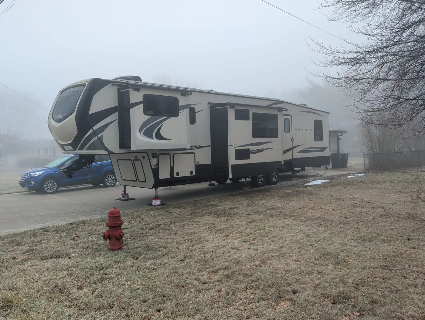 Fifth wheel parked on a foggy morning ahead of a service appointment