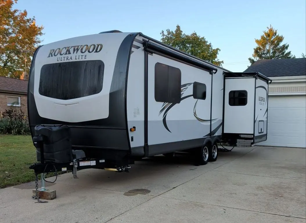 Travel trailer parked in a driveway during a seasonal service call