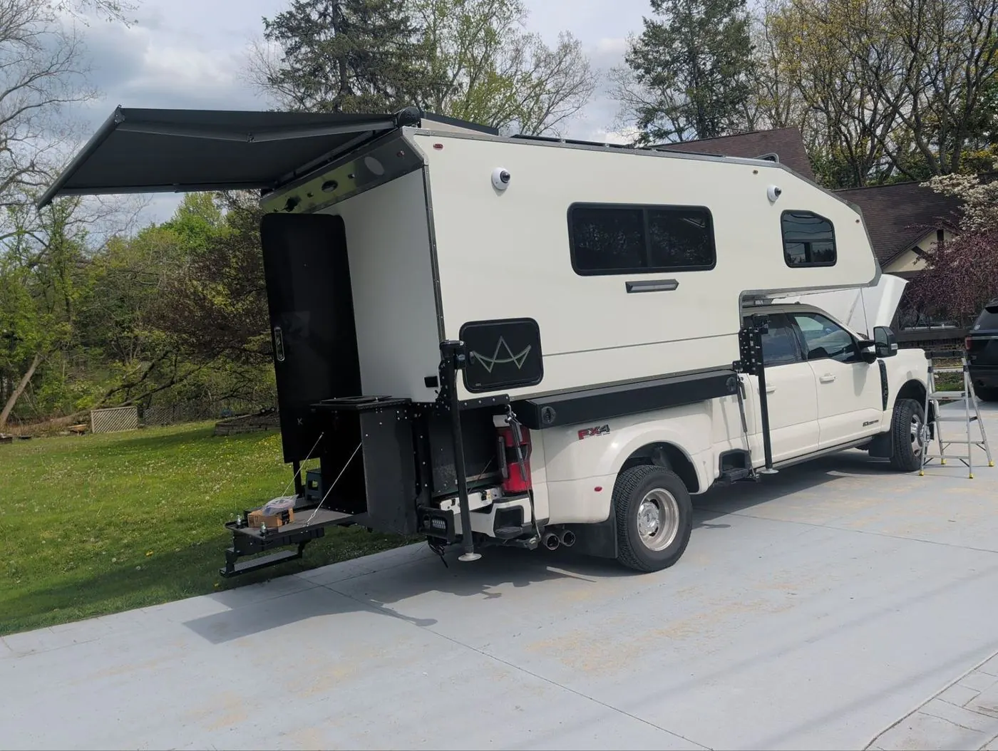 Truck camper mounted on a dually pickup with the awning extended
